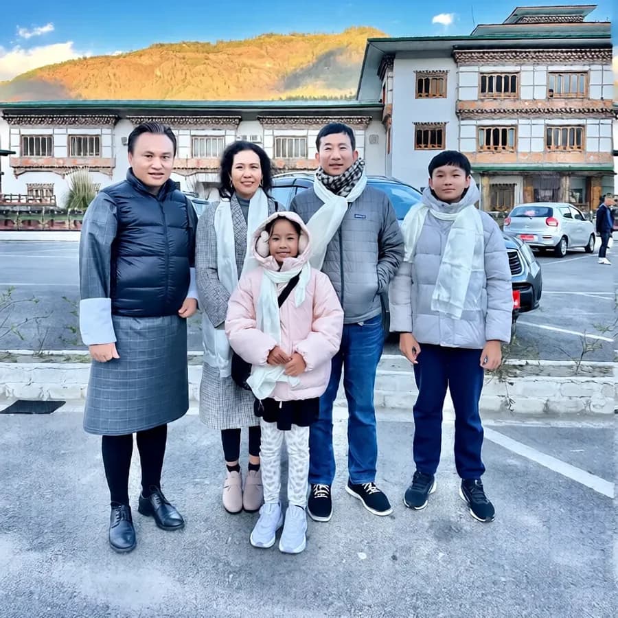 A family of travelers posing together in Bhutan