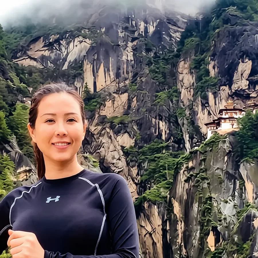A traveler on the hiking trail with Taktsang, the Tiger's Nest monastery, in the background