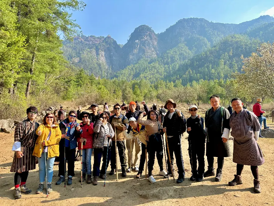 Happy travelers celebrating after completing the hike to Tiger’s Nest Monastery in Bhutan.