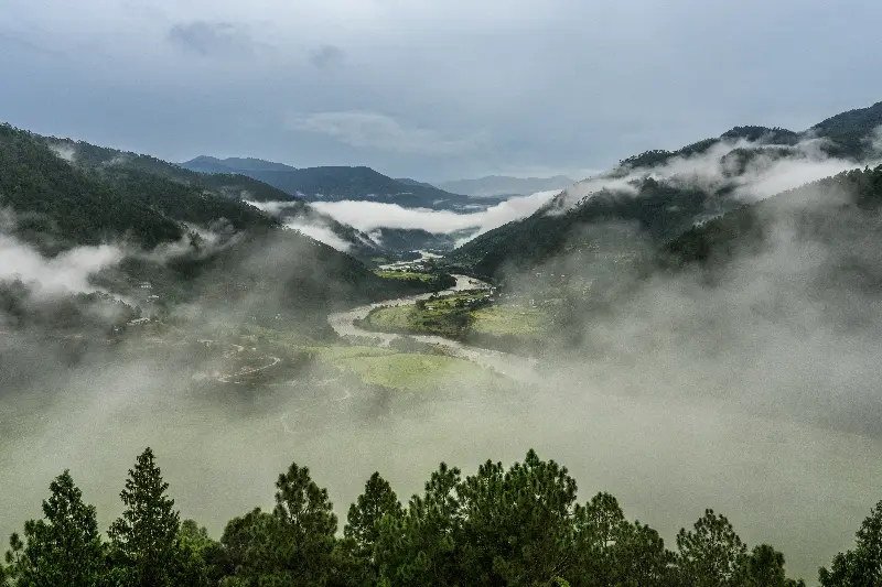 Punakha Valley covered in mist with Bhutanese mountain landscapes