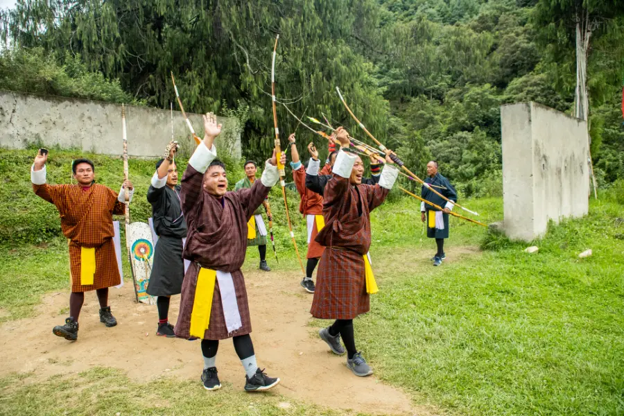 Bhutanese archers encouraging each other during a traditional archery competition.