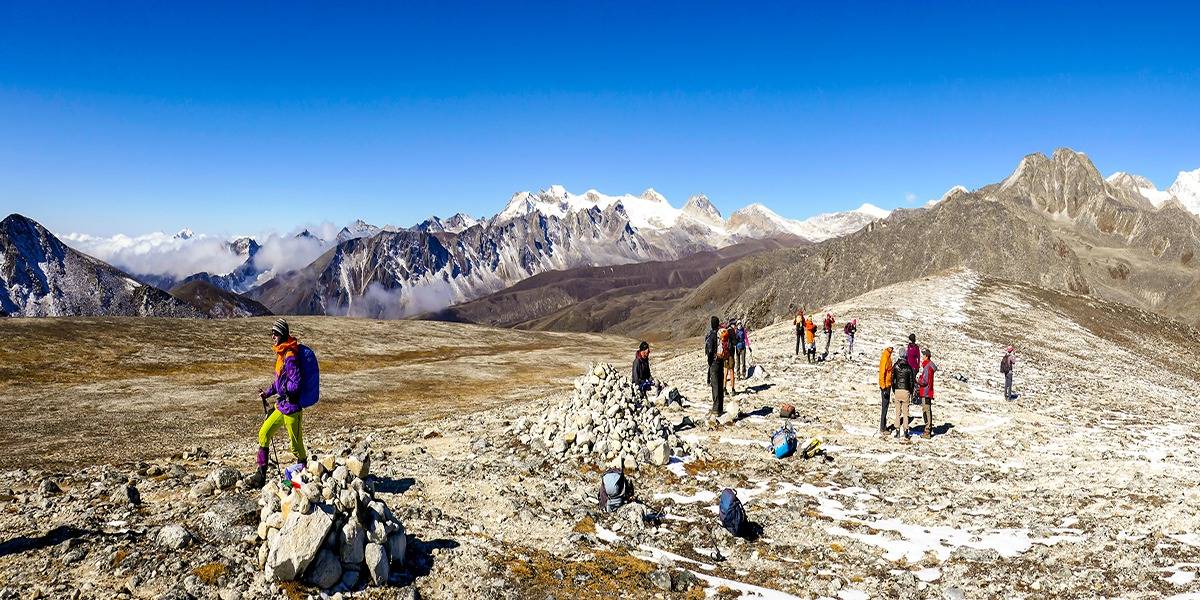 Trekkers hiking through the Himalayan mountains on a Bhutan trekking tour 